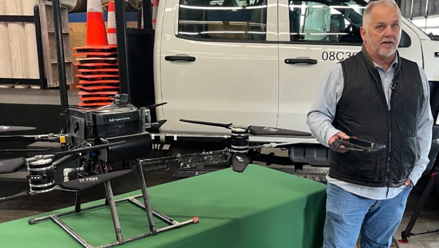 Lakewood Maintenance Superintendent Michael Gauger Alongside The Prototype Anti-Graffiti Drone. (Image Credit: Chris Sullivan, Kiro Newsradio)