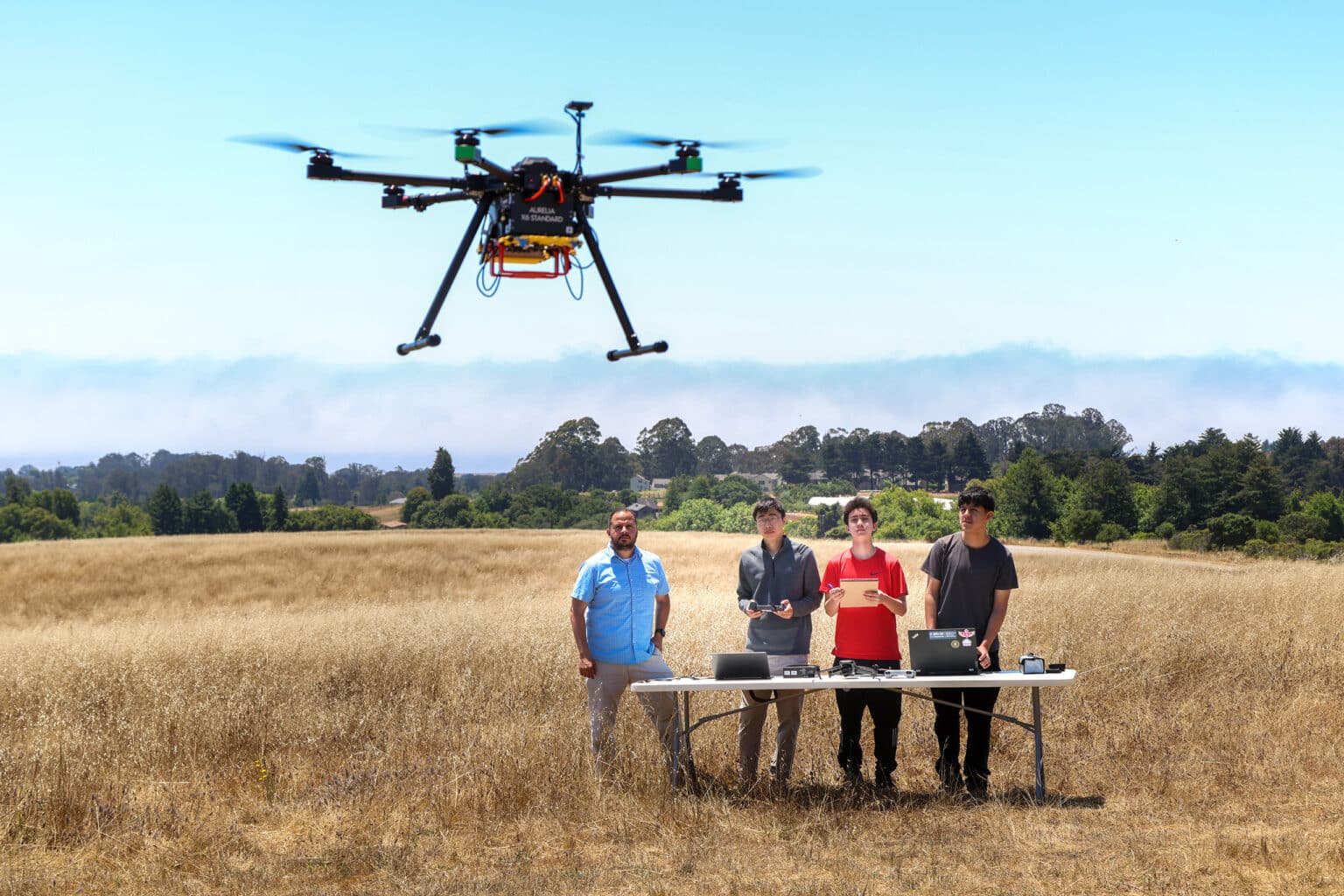 Javier Gonzalez-Rocha, Ucsc Professor Photo With Uc Santa Cruz Students Observing Their Air Quality Sensing Drone | Photo Credits: Ucsc