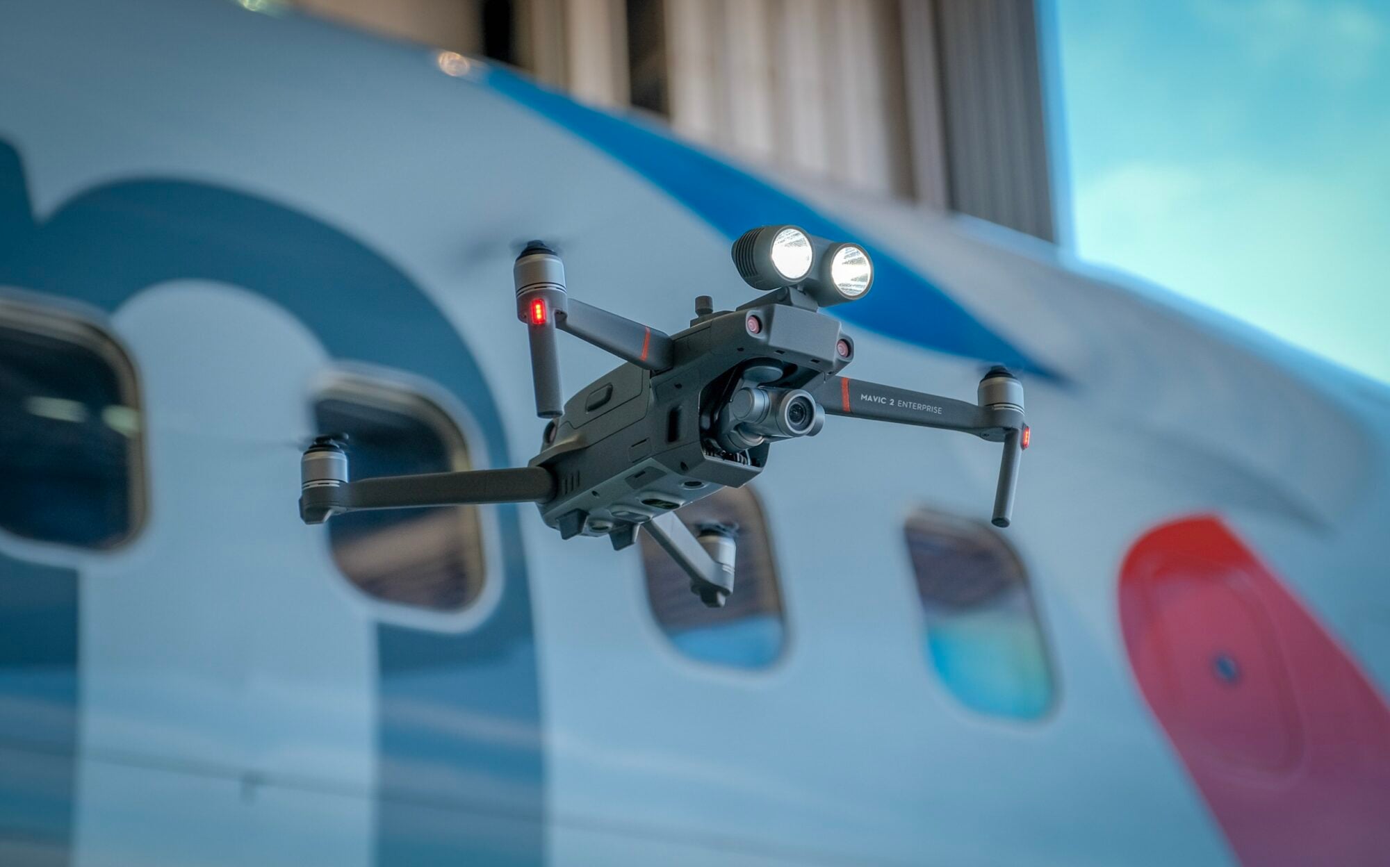 Dji Mavic 2 Enterprise Drone At A Demonstration From Dji During The Dji Airworks Event In 2018 At The Dallas-Forthworth Airport In Texas With An American Airlines Plane In The Background.